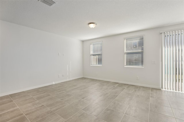 spare room featuring a textured ceiling