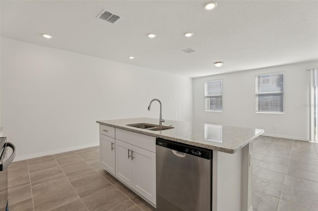 kitchen featuring sink, dishwasher, white cabinetry, light stone countertops, and a center island with sink