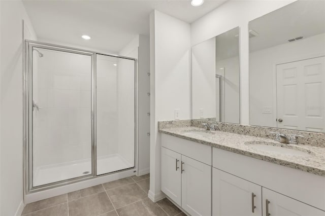 bathroom featuring vanity, an enclosed shower, and tile patterned floors