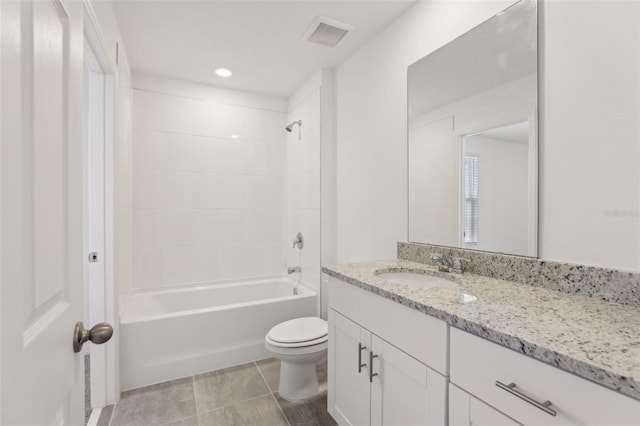 full bathroom featuring tiled shower / bath, vanity, toilet, and tile patterned floors