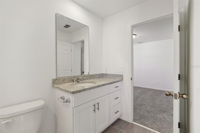 bathroom with vanity, tile patterned floors, and toilet