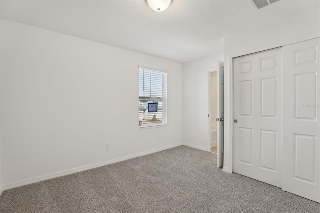 unfurnished bedroom with a closet and carpet flooring