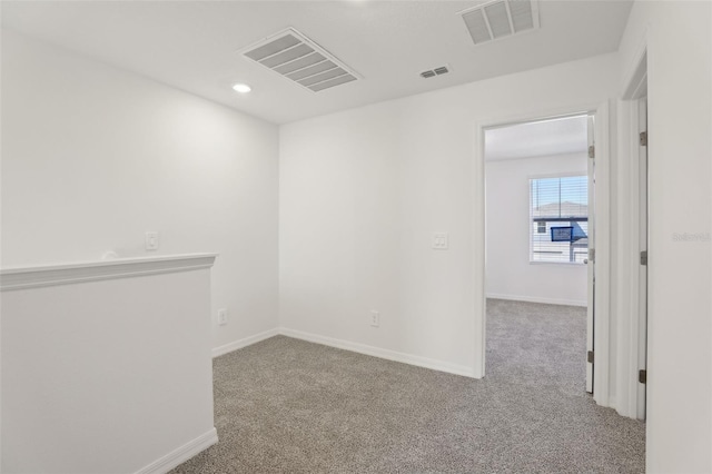 unfurnished room with light colored carpet