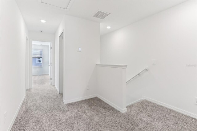 hallway with light colored carpet