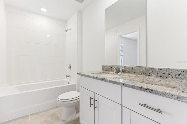 full bathroom featuring tile patterned floors, toilet, tiled shower / bath combo, and vanity