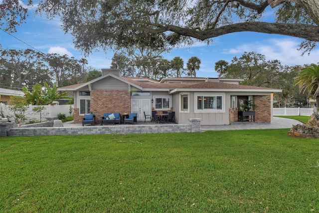 back of house with a yard and a patio area