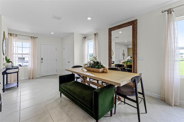 tiled dining space featuring plenty of natural light