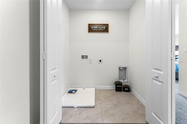 clothes washing area featuring washer hookup, electric dryer hookup, and light tile patterned floors