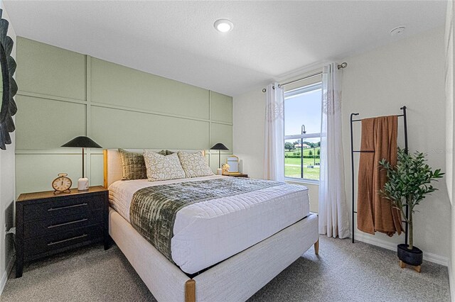 carpeted bedroom with a textured ceiling