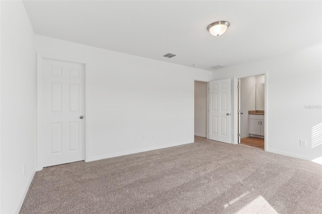 unfurnished room with light colored carpet