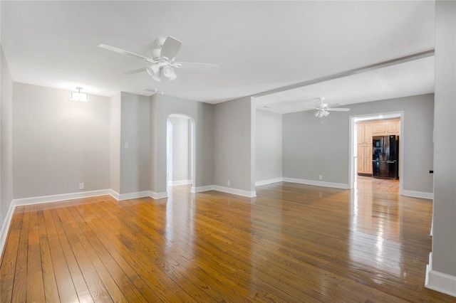 empty room featuring wood-type flooring and ceiling fan