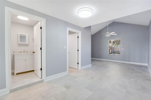 unfurnished room with ceiling fan, lofted ceiling, and sink