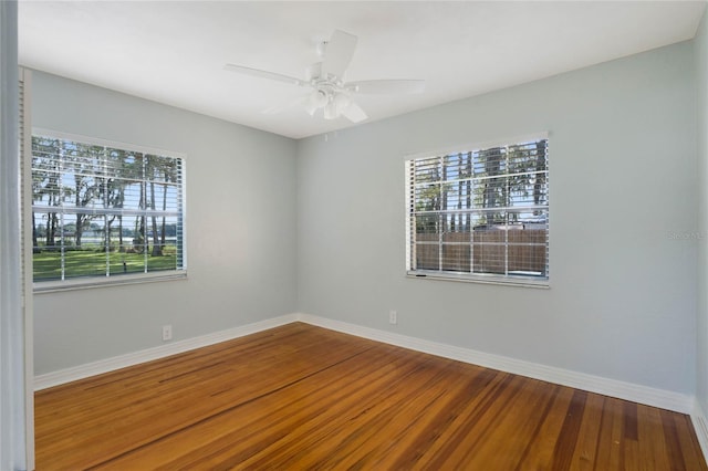 unfurnished room featuring ceiling fan, plenty of natural light, and wood-type flooring