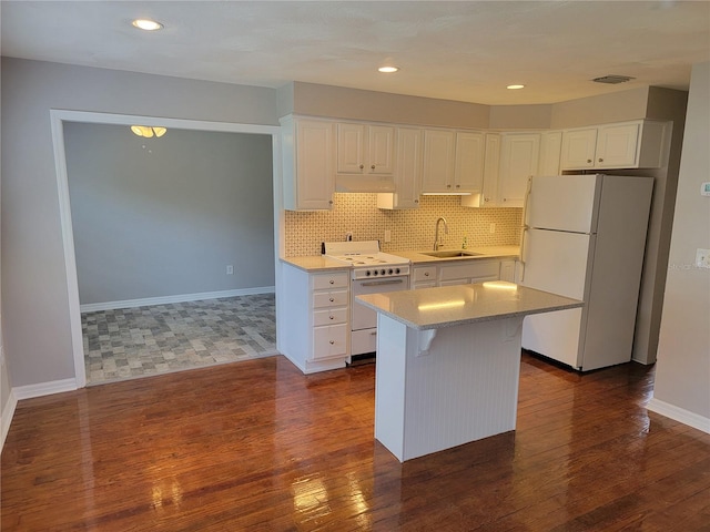 5625 Chipola Cir, Orlando, FL 32839 - kitchen with white appliances, white cabinets, dark wood-type flooring, a sink, and recessed lighting