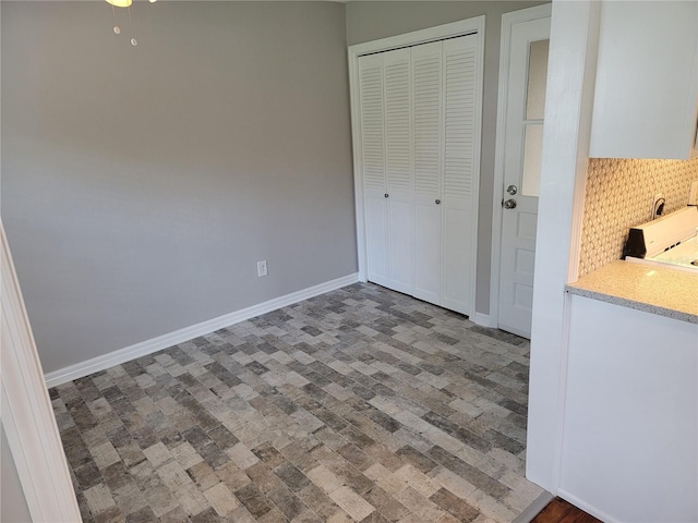 5625 Chipola Cir, Orlando, FL 32839 - unfurnished bedroom with brick patterned flooring, a closet, and baseboards