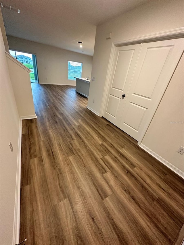 interior space with baseboards and dark wood finished floors