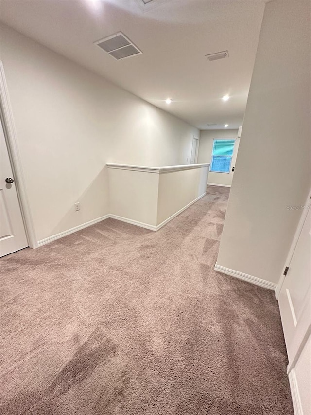 spare room featuring visible vents, recessed lighting, baseboards, and light carpet