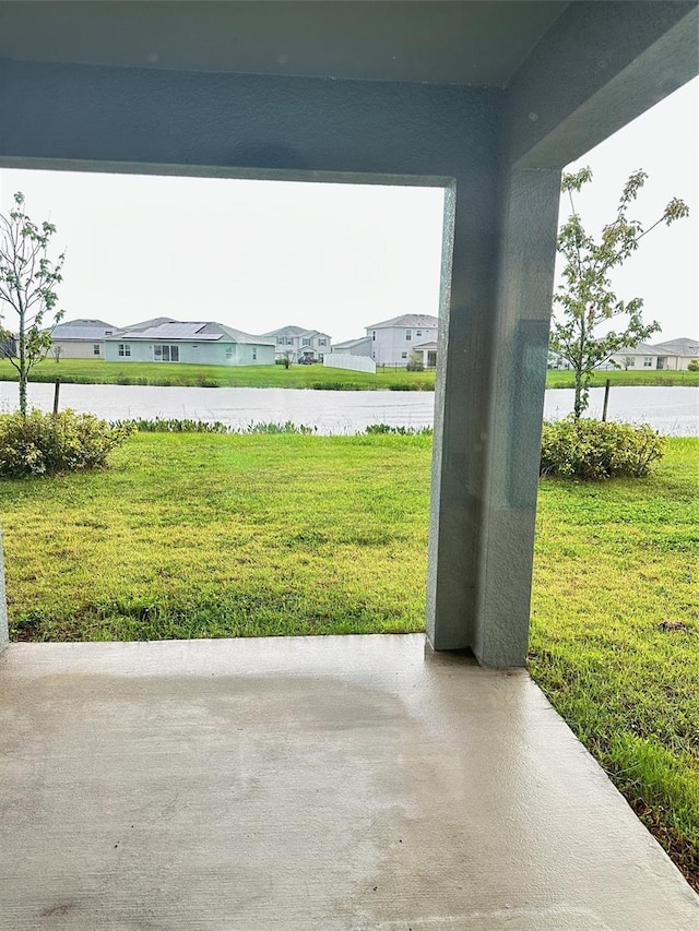 view of patio featuring a residential view and a water view