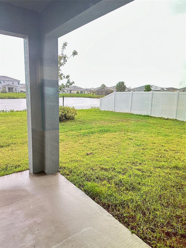 view of yard featuring a water view and a patio area