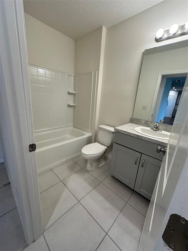 full bath featuring tile patterned floors, toilet, shower / bath combination, vanity, and a textured ceiling