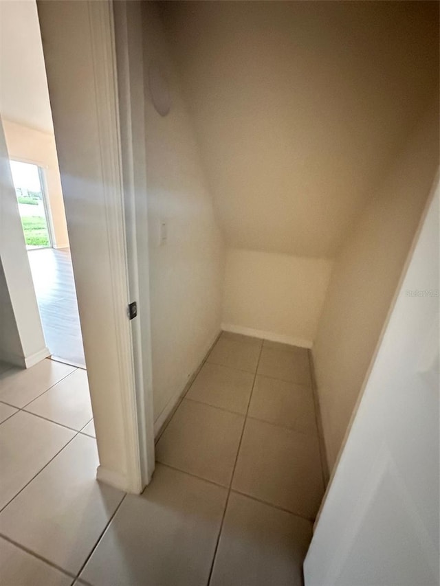 hall with light tile patterned floors and baseboards