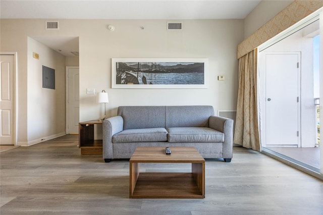 living room featuring electric panel and hardwood / wood-style floors