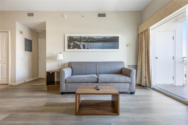7383 Universal Blvd Unit 710, Orlando, FL 32819 - living room featuring baseboards, electric panel, wood finished floors, and visible vents