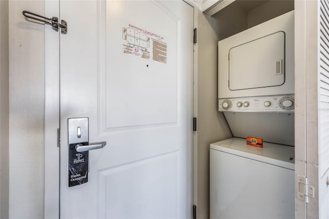 laundry area with stacked washing maching and dryer