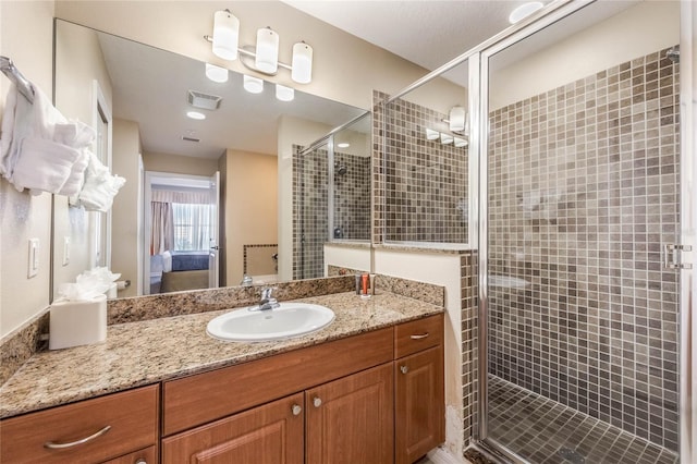 bathroom featuring walk in shower and vanity