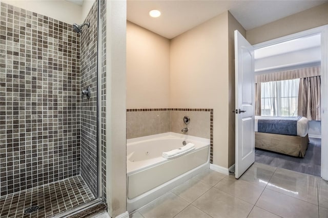 bathroom with independent shower and bath and tile patterned flooring