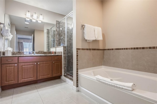 bathroom featuring tile patterned flooring, vanity, and separate shower and tub