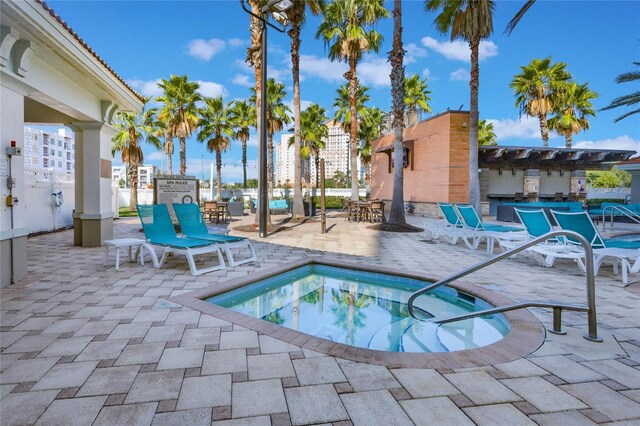 view of pool featuring a community hot tub and a patio area