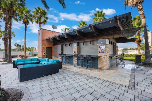 view of patio / terrace featuring an outdoor bar, a pergola, and an outdoor hangout area