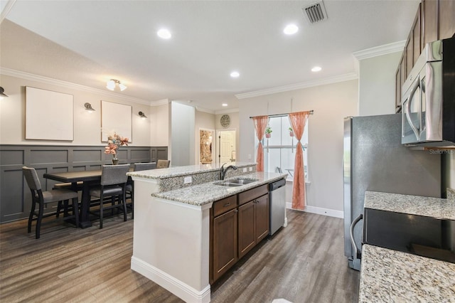 kitchen featuring ornamental molding, hardwood / wood-style flooring, stainless steel appliances, and sink