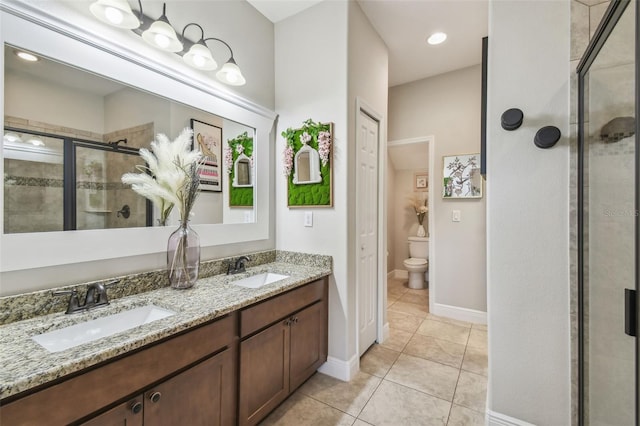 bathroom featuring vanity, tile patterned floors, an enclosed shower, and toilet