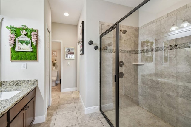 bathroom featuring vanity, toilet, tile patterned floors, and a shower with door