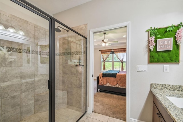 bathroom with ceiling fan, vanity, an enclosed shower, and tile patterned floors