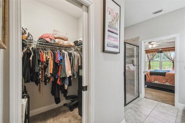 walk in closet featuring ceiling fan and light tile patterned floors