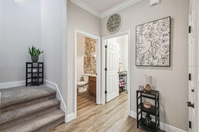 interior space with ornamental molding and light hardwood / wood-style floors