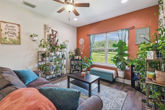 living room with dark wood-type flooring and ceiling fan