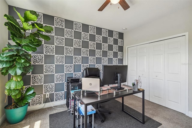 carpeted office space featuring ceiling fan