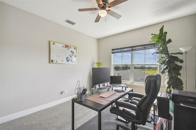 carpeted office space with ceiling fan