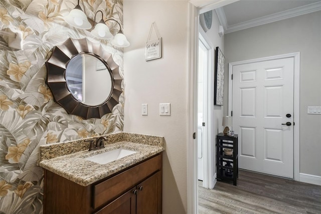 bathroom with ornamental molding, vanity, and hardwood / wood-style flooring