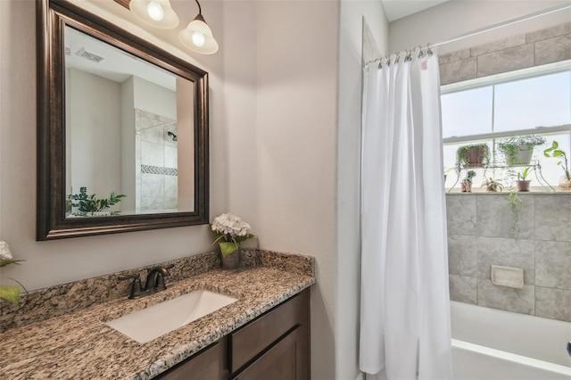 bathroom featuring vanity and shower / bath combination with curtain