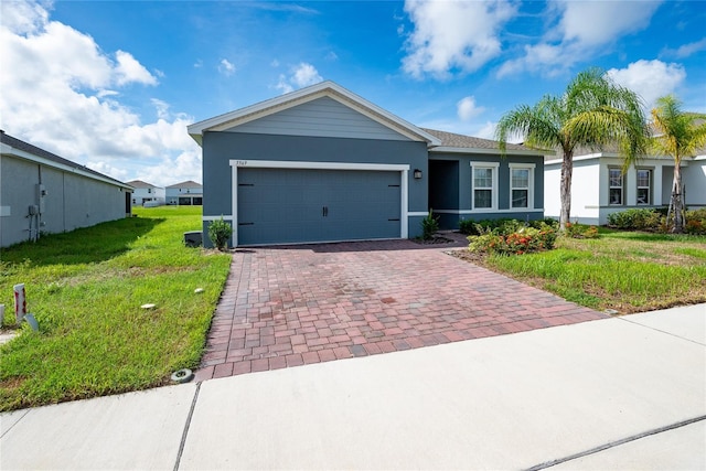 ranch-style house featuring a front lawn and a garage