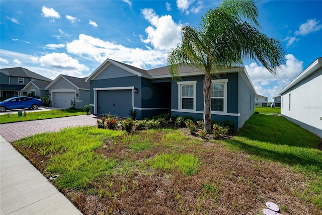 single story home featuring a garage and a front yard