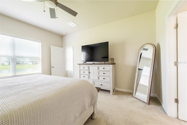 bedroom featuring light carpet and ceiling fan