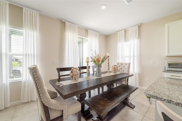 dining area featuring light tile patterned floors