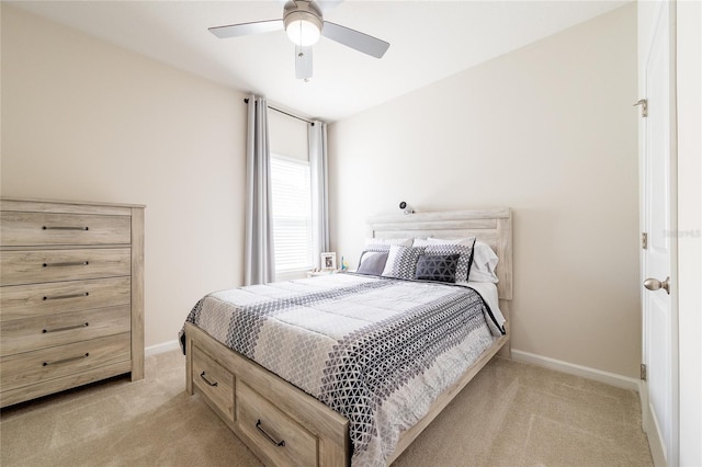 bedroom with ceiling fan and light carpet