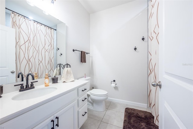 bathroom with vanity, tile patterned flooring, and toilet